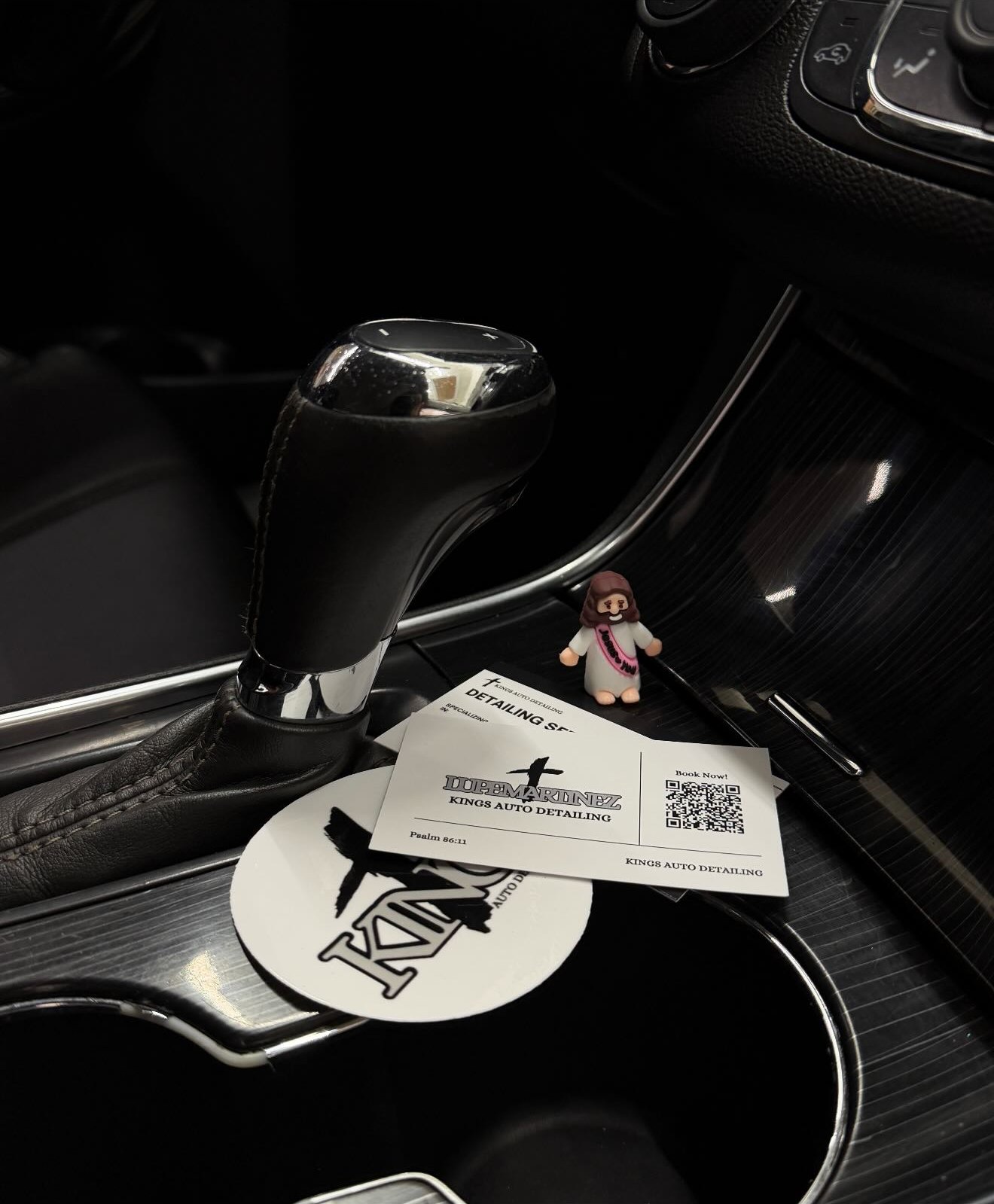 Kings Auto Detailing cards on a detailed center console